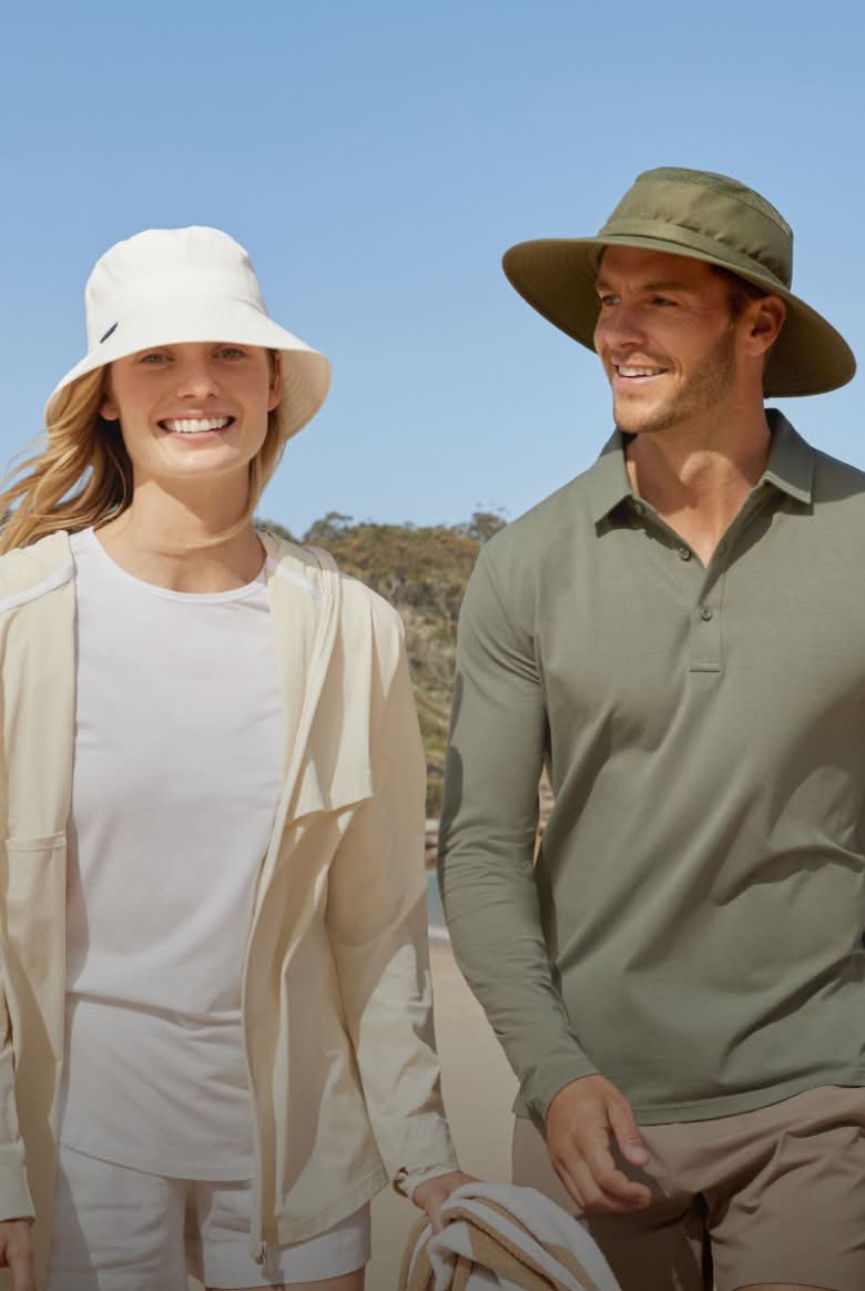 Two people wearing hats outdoors on a sunny day