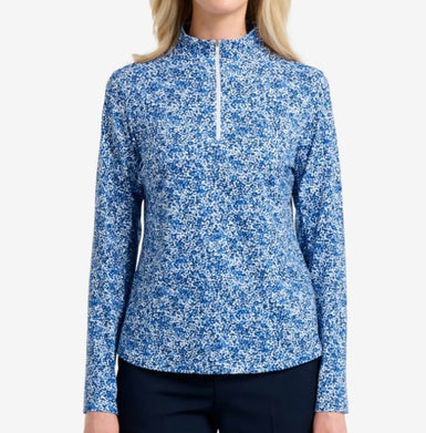 Blue and white patterned long-sleeve top worn by a person on a white background